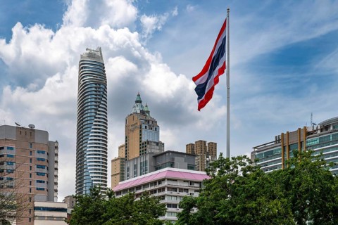 Thailand flag and Magnolias Ratchadamri Boulevard Residence, Bangkok, Thailand
