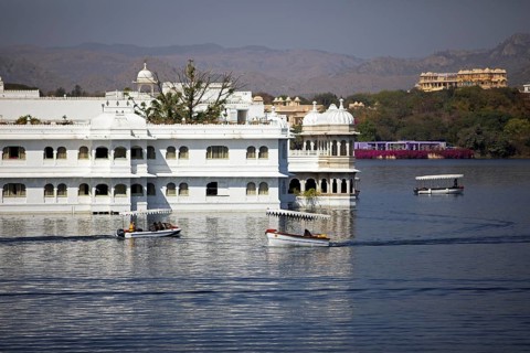 Boats on Lake Pichola, behind the Taj Lake Palace Hotel, Udaipur, Rajasthan, India