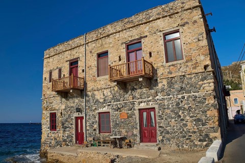 Two-storey stone house with red windows right by the sea, rustic charm, Agia Marina, Leros,