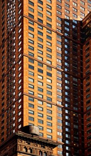 Skyscraper facades, below a wooden water tank on the roof of a residential building, New York