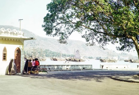 Group women and nuns at quayside with Chinese junks in harbour, Macau, Asia 1964