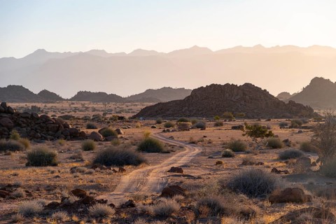 Sandy track, desert landscape in the evening light at sunset, backlit, Brandberg, Erongo,