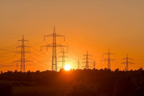 Electricity pylons in front of a glowing sunset on the horizon, Waiblingen, Baden-Württemberg,