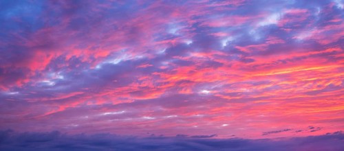 Background image for sky replacement, evening sky with illuminated red clouds at dusk after sunset