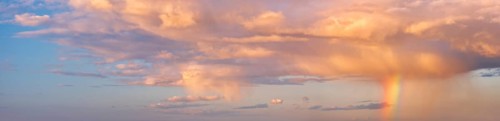 Background image for sky replacement, evening sky with illuminated clouds, rain shower and rainbow