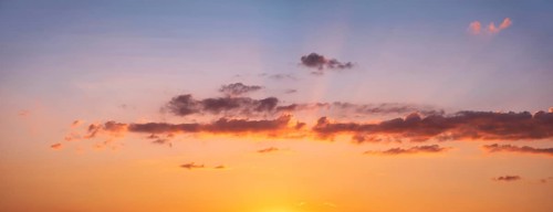 Wallpaper for sky replacement, evening sky with orange glowing clouds and sun rays at sunset