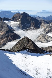 At the Wilder Freiger summit, picturesque high mountain landscape with snow, view of the