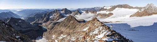 Mountaineer on a rocky ridge on the Wilder Freiger mountain peak, behind signal peak and Becher