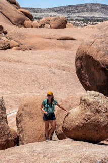 Tourist with camera, rock formation, Pontok Mountains, Spitzkoppe, Große Spitzkuppe Nature Reserve,