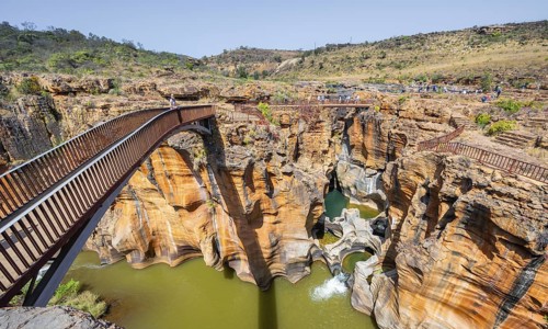 Bridges over a canyon with steep orange-coloured cliffs and the Blyde River, Bourke's Luck