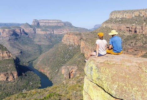 Two hikers enjoying panorama, Blyde River Canyon with Three Rondawels peak, view of gorge with