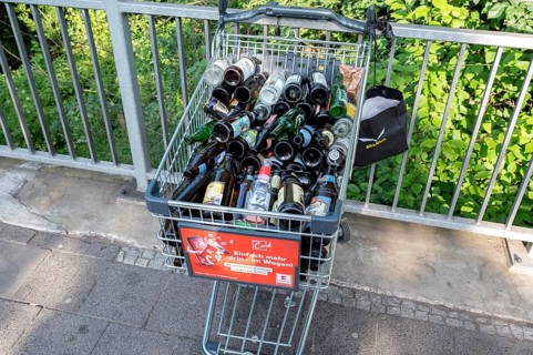 Shopping trolley overflowing with empty beer bottles on the mountain, Erlanger Bergkirchweih,