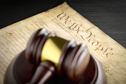 United states constitution and gavel resting on table