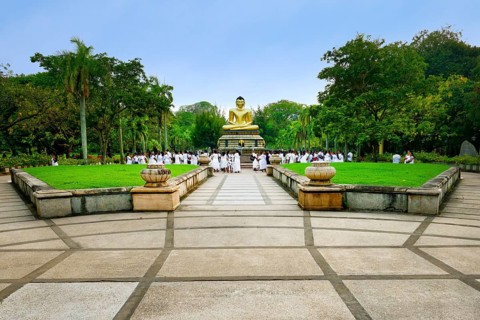 Pilgrims in front of a Buddha statue, Colombo, Sri Lanka