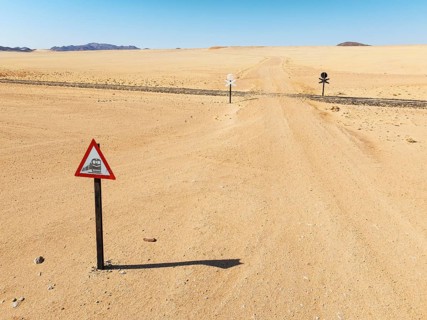Rails and level crossing in the southern Namib Desert. Aerial view. Drone shot. Namibia