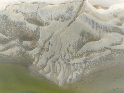 Low tide patterns and Greater Flamingos (Phoenicopterus ruber) at the Walvis Bay Lagoon. Aerial