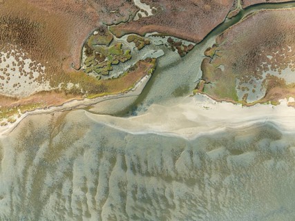 Marshes and streams at low tide in the Walvis Bay Lagoon. Aerial view. Drone shot. Namibia