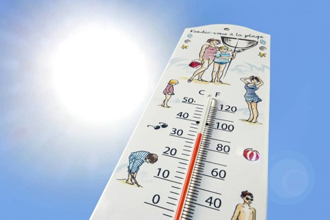 Worm's-eye view of thermometer measures extremely hot temperature of 34 degrees Celsius, 34 °C, 93.