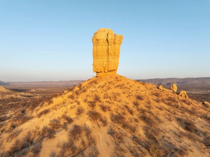 The Vingerklip (rock finger) is surrounded by thornbush and mopane (Colophospermum mopane) savanna.
