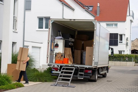 Relocation symbolic image: lorry being unloaded in front of a residential building