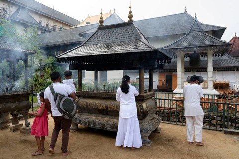 Temple of the sacred Tooth Relic or Sri Dalada Maligawa, Pilgrims burning incense, Kandy, Sri Lanka