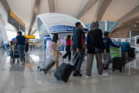 Airport people with luggage, Abu Dhabi, United Arab Emirates