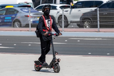 Man with electric scooter, Abu Dhabi, United Arab Emirates