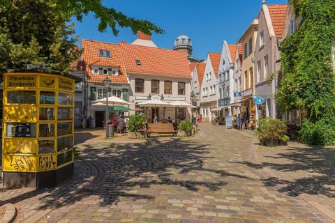 Renovated Schnoor district with small shops, square with historic public telephone, telephone box,