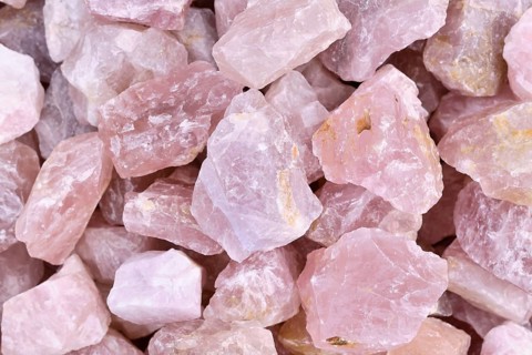 Close up of raw large rose quartz crystals. Natural pink gemstone chunks used for healing or