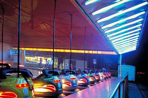 Illuminated bumper cars at night, New Jersey, USA