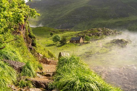 Hiking trail and mountain hut at the Lac des Gloriettes reservoir in the Pyrenees near