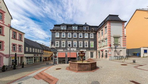 Market street with pharmacy fountain in Ilmenau, Thuringia, Germany