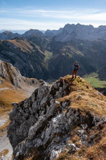 Mountaineers on a hiking trail on the Gamsjoch, picturesque mountain landscape in autumn, view of