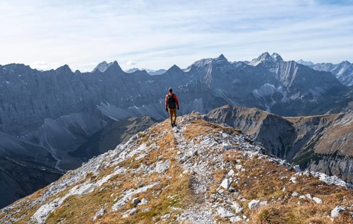 Mountain panorama with picturesque mountain landscape, mountaineers descending from the Gamsjoch,