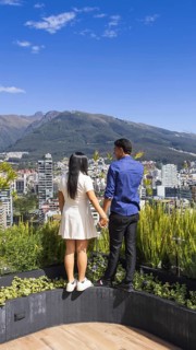 Quito, Ecuador, May 2 2025: Young tourist couple overview Carolina Park modern condominiums in