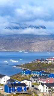 Panoramic view of Greenland capital Nuuk with colored houses located near fjords and icebergs