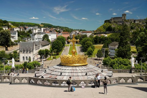 The gilded crown of the Basilica of the Rosary, Rosary Square and ChÃ¢teau fort de Lourdes fortress