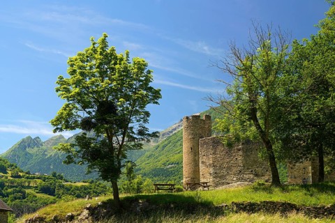The ruins of the ChÃ¢teau Sainte-Marie castle in Esterre and the mountain landscape near