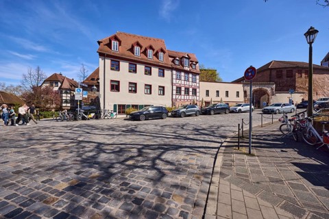 Street, cobblestone pavement, historic buildings, half-timbered house, lantern, parking lane with
