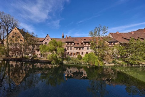 River Pegnitz, historical buildings, trees, symmetrical reflections, water surface, blue sky,