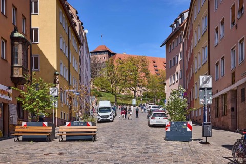 Street, traffic sign end of pedestrian zone, cobblestones, flower pots, benches, historical