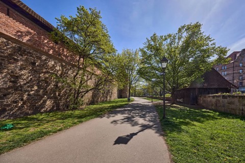Old town, city fortification, city wall, footpath, trees, lawn, lantern, backlight, shadow, blue