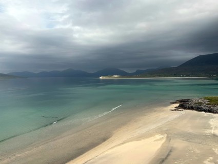 Stormy coastal view with grey sky and calm sea to the shore of a wide bay, Outer Hebrides, Isle of