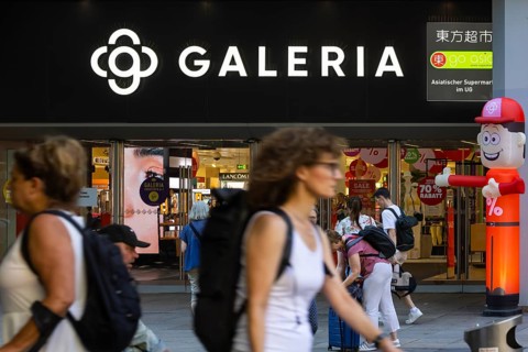 Galeria Kaufhof. Logo and entrance of the department stores' with people in Stuttgart,