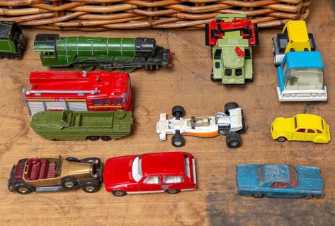 A selection of children's toy cars trucks train for sale on display at auction, UK