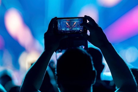 A concertgoer films Lionel Richie with his smartphone on the Say Hello To The Hits 2025 Tour at the
