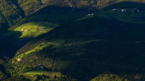 View of the Sonnenberg with Annenberg Castle and the farms above in the evening light, Dolomites,