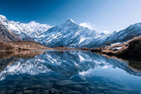 Alpine snow-peaked mountain landscape with trees reflecting in the water of pristine lake, AI