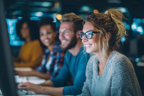 Diverse employees in corporate environment support center analyzing data and helping customers to