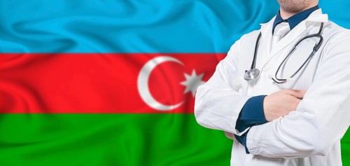 Azerbaijan healthcare concept. Male doctor on Azerbaijan flag. Doctor with crossed arms on